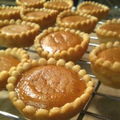 many small pies are cooling on a rack