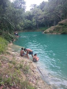 some people are playing in the water and swimming