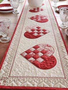 a table runner with red and white designs on it