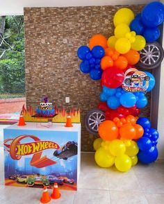 balloons are arranged in the shape of a car on display at a hot wheels birthday party