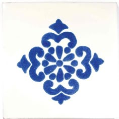 a blue and white tile with an ornate design