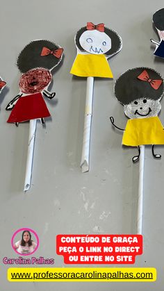 there are some paper dolls on top of toothpicks in the shape of children's faces