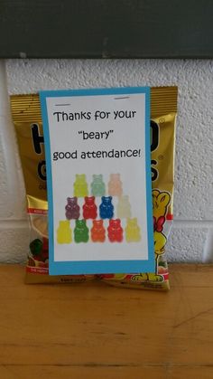 a bag of gummy bears sitting on top of a table next to a sign that says thanks for your bear good attendance