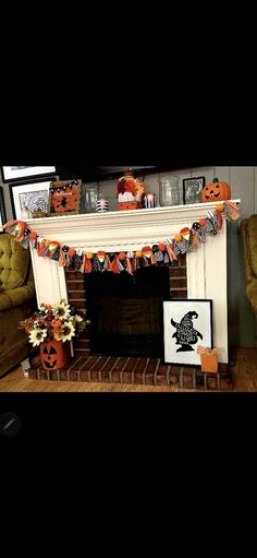 a fireplace decorated for halloween with pumpkins and decorations