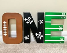 the letters are made out of wood and have footballs on them