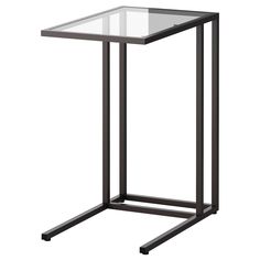 a glass and metal side table on a white background