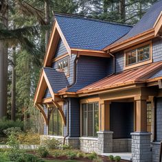 a house with blue shingles and wood trim