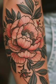 a woman's arm with flowers and leaves on it