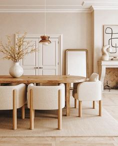 a dining room with beige walls and white chairs