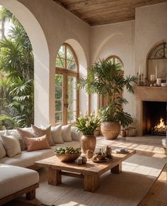 a living room filled with furniture and a fire place in the middle of it's walls