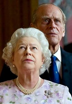 an older man and woman standing next to each other