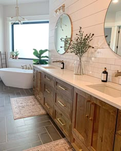 a large bathroom with two sinks and a bathtub in it's center area