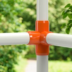 the yellow and white poles are connected to each other by two plastic posts, with trees in the background