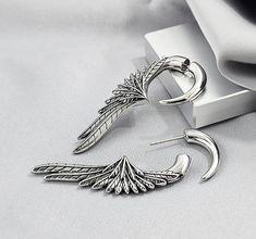 ⚡PLEASE READ BEFORE PURCHASING⚡ 💖SOLD AS 1 PC. (SINGLE) OR 2 PCS. (PAIR)💖 🪄 FAKE GAUGE LOOK 🪄  This style of earrings may be heavy for some people  Design: Big Wing Claw Earring Metal Material: 316L SURGICAL STEEL Finish: Oxidized Front Claw Dimension: 5W X 21H MM Back Wing Dimension: 13.5W X 50H MM Stem Thickness: 20G / Approx. 0.85MM Post Backing: Push-In Closure Weight Per 1 pc. Earring: 9 grams SHIPPING ADDRESS  We are not responsible for the incorrect address you provided. Therefore, we Edgy Emo, Angel Wings Jewelry, People Design, Claw Earrings, Fake Gauges, Wing Jewelry, Earrings For Men, Gothic Earrings, Ear Jacket