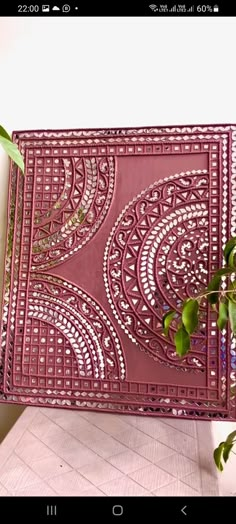 a pink tray sitting on top of a table next to a potted plant