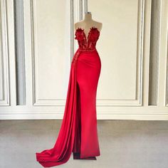 Step into the spotlight with this sensational red evening gown. Featuring a dramatic plunging neckline adorned with intricate lace details and delicate beadwork, this dress exudes sophistication and charm. The fitted bodice elegantly accentuates your silhouette, ensuring you make a memorable entrance at any event.Crafted from luxurious, high-quality fabric, this gown offers both comfort and timeless style. The floor-length skirt flows gracefully with every step, while the side drape adds a touch Red Evening Gown, Red Lace Prom Dress, Classic Glamour, Knee High Boots Flat, Jessica Rabbit, Patterned Tights, Solid Leggings, Spaghetti Strap Tank Top, Floor Length Skirt