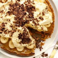 there is a pie with bananas and whipped cream on the top, topped with chocolate shavings