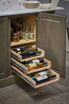 an open cabinet with wine bottles in it