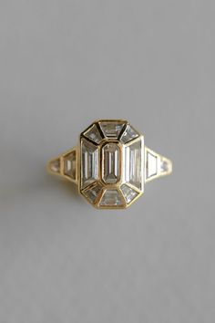 an antique diamond ring with three baguettes in the center and two diamonds on each side