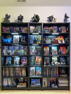 a book shelf filled with batman action figures