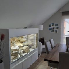 a dining room table and chairs with an aquarium in the middle