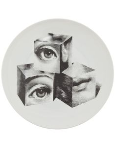 a white plate with black and white images on it that have eyes in the middle