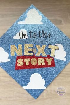 a blue graduation cap with the words on to the next story written in gold glitter