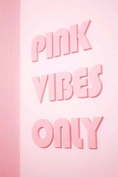 the words pink vibes only are cut out of foam letters on a pink wall