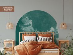 a bed with pillows and blankets in front of a green painted circle on the wall