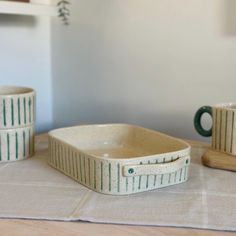 three ceramic dishes sitting on top of a table