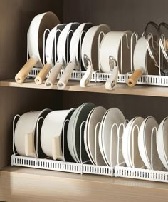 the shelves are filled with dishes and pans