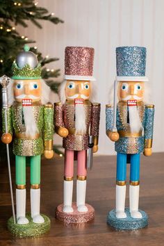 three nutcracker figurines are standing next to each other on a table