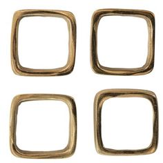 four square brass rings on a white background