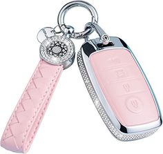 a pink leather key chain with a watch on it's side and a diamond - encrusted case