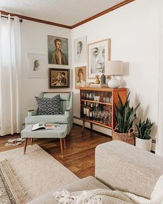 a living room filled with furniture and pictures on the wall