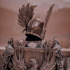 a statue of a man in armor with wings on his back