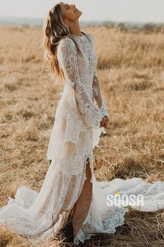 a woman standing in a field wearing a white dress