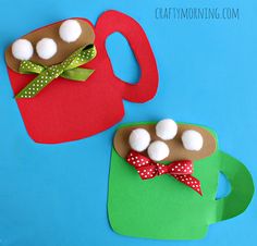 two paper coffee mugs with marshmallows on them, one is red and the other is green