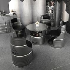 a room that has some tables and chairs around it in black and silver colors with hexagonal tiles on the walls