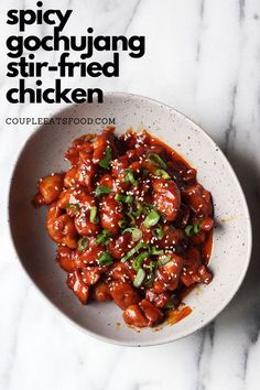 a white bowl filled with chicken covered in sauce