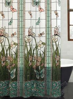 a bath tub sitting next to a shower curtain with flowers and butterflies painted on it