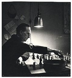 black and white photograph of a man playing chess