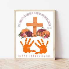 a cross and handprints are on the floor next to a wooden frame that says happy thanksgiving