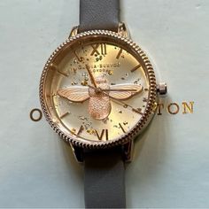 Enjoy Gorgious And V Unique Looking Olivia Burton Ob16gd06 Celestial 3d Bee Demi Dial Watch With 34mm Silver Tone Sunray Face With Rosegold & Silver Glitters & Flacks In The Back Ground & Lighter Rosegold 3d Bee Figurine On The Dial & Rosegold Roman Numerals Hourmarkers & Rosegold Hands & Rosegold Bezel With Coinedge Trim Around Its Bezel & Grey Leather Band. Its Original Retail Price Is $225 & Overheads Enjoy The Gorgeous Watch At Great Discount. Elegant Rose Gold Watch Accessories With Skeleton Dial, Rose Gold Watches With Skeleton Dial, Classic Rose Gold Watch With Skeleton Dial, Luxury Rose Gold Watch With Skeleton Dial, Bee Figurine, Olivia Burton Watch, Back Ground, Olivia Burton, Roman Numerals