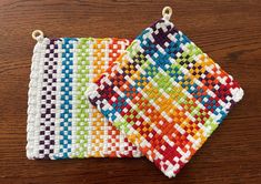 two small crocheted coasters sitting on top of a wooden table