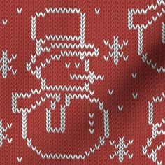 a red and white knitted sweater with the word love written in large letters on it