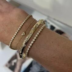 This sleek bangle captivates with scattering flush set diamonds set in 14k gold. Carefully crafted with comfort in mind, this bangle is easy to wear every day and a perfect addition to your stack if you're wanting to add more gold with a touch of sparkle! Available in 14k Yellow Gold, White Gold or Rose Gold Total Carat Weight: 1.75 cts Color: G/H Clarity: VS2 Closure: Hinge Made to order. Lead time is 4 weeks. Benefits of Solid 14k Gold Jewelry Most loved for its durability and longevity Can be Gold Bracket Stack, Gold And Diamond Bracelet, Flush Set Diamond, Stacked Bangles, Classy Jewelry, Gold Diamond Jewelry, Jewelry Essentials, Stacked Jewelry, Jewelry Lookbook