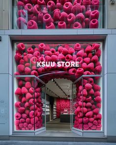 a store front with pink decorations in the window and on the outside wall that says kosuu store