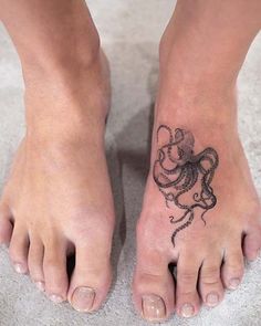 a woman's foot with a tattoo on it that has an octopus in the shape of a heart