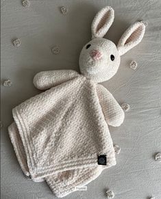 a crocheted bunny laying on top of a blanket